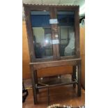 OAK GLAZED TWO DOOR CABINET ON STAND