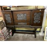 OAK INVERTED BREAK FRONT CABINET WITH CARVED ORIENTAL PANELS