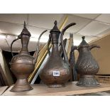 THREE EASTERN COPPER COFFEE POTS