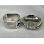 20 SEN COIN BEATEN WHITE METAL SHALLOW DISH AND A SILVER NAPKIN RING WITH ENGINE TURNED DECORATION