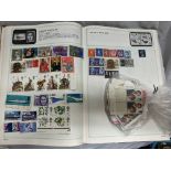 STANLEY GIBBONS STRAND STAMP ALBUM AND BAG OF LOOSE POSTAGE STAMPS