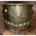 BRASS REPOUSSE LOG BIN WITH LIONS FACE MASK HANDLES AND FLEUR DE LYS DECORATION