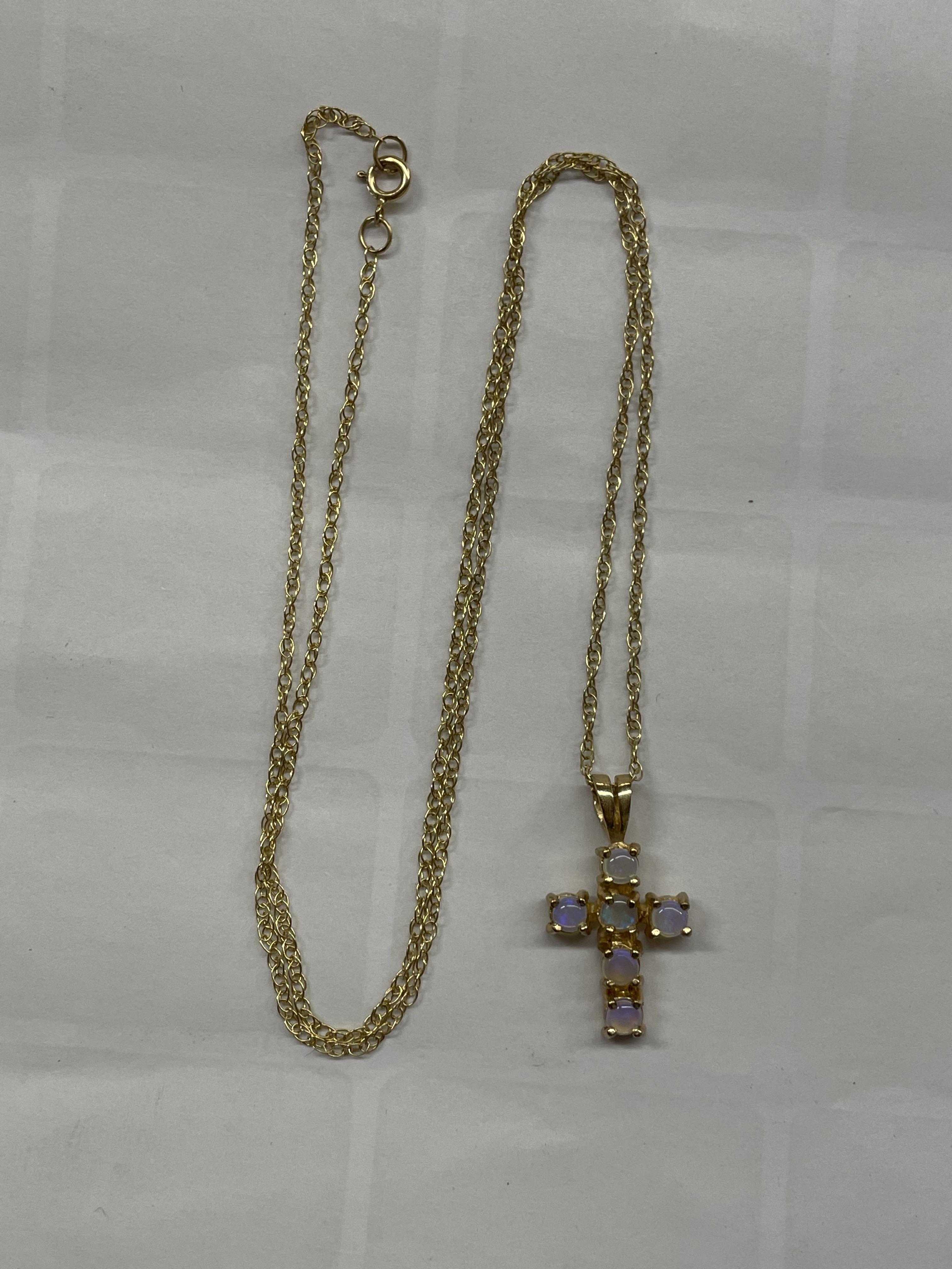 9CT MOONSTONE CROSS ON A FINE TRACE CHAIN 1.