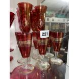 SIX LAURA ASHLEY RUBY TINTED ETCHED FLUTES AND SIX RUBY AND GILDED GLASSES