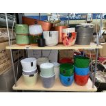 TWO SHELVES OF LOZENGE PATTERNED AND COLOURED POTS AND PLANTERS