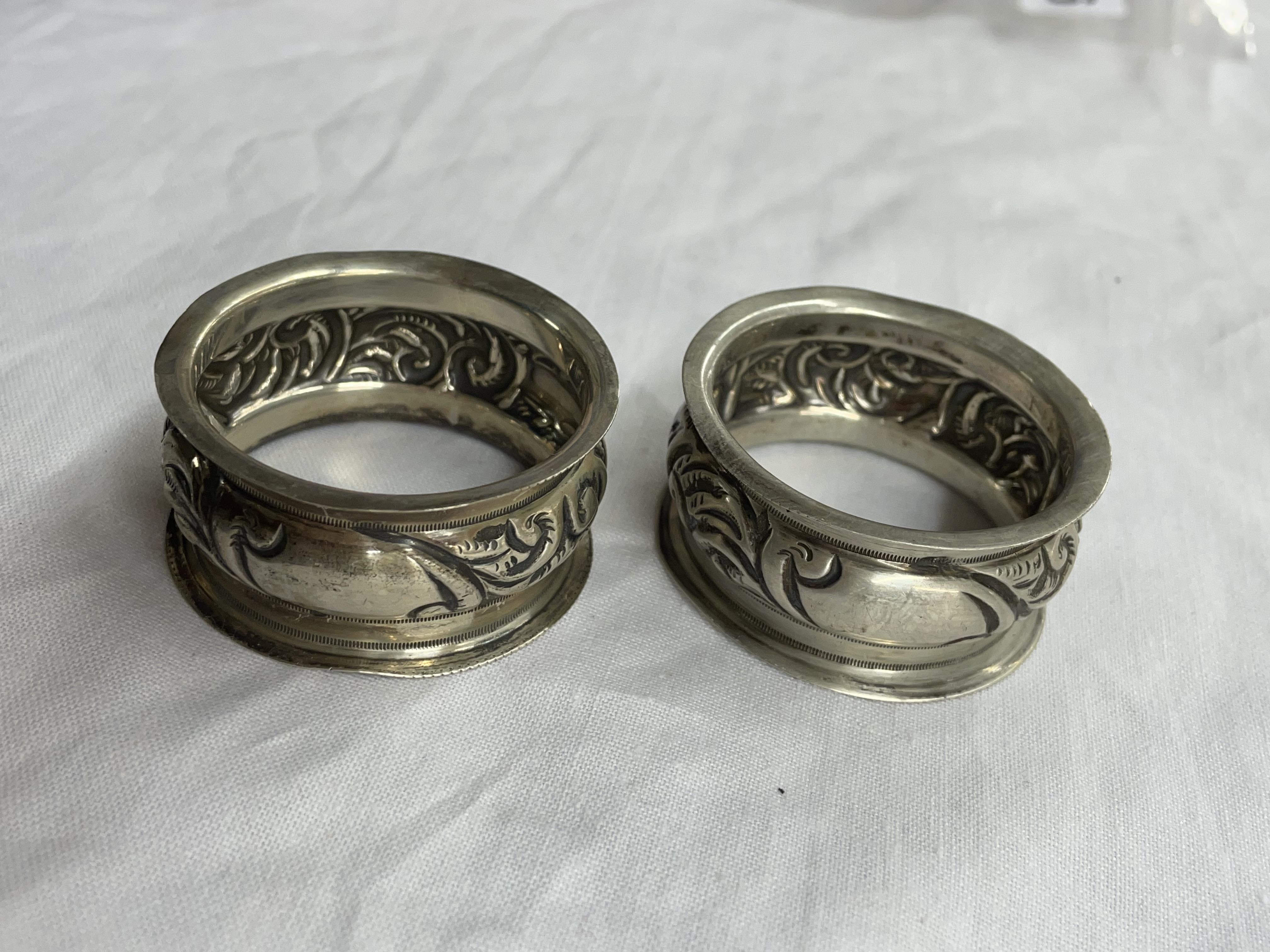 PAIR OF SILVER EMBOSSED NAPKIN RINGS