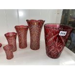 RUBY GLAZED CUT ETCHED TAPERED VASE AND SET OF FOUR GRADUATED FLARED VASES