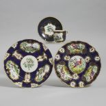 Two Samson 'Worcester' Scale Blue Ground Exotic Bird Plates and a Cup and Saucer, c.1900, largest di