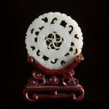 A White Jade Reticulated Circular Plaque, Qing Dynasty, 清 白玉透雕转心佩, diameter 2.3 in — 5.8 cm