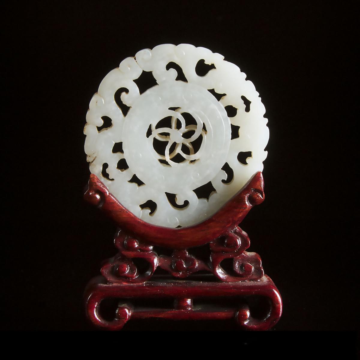 A White Jade Reticulated Circular Plaque, Qing Dynasty, 清 白玉透雕转心佩, diameter 2.3 in — 5.8 cm - Image 2 of 2