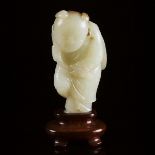A White and Russet Jade Carving of a Boy Holding Lingzhi, Qing Dynasty, Late 19th Century, 晚清 白玉雕童子持