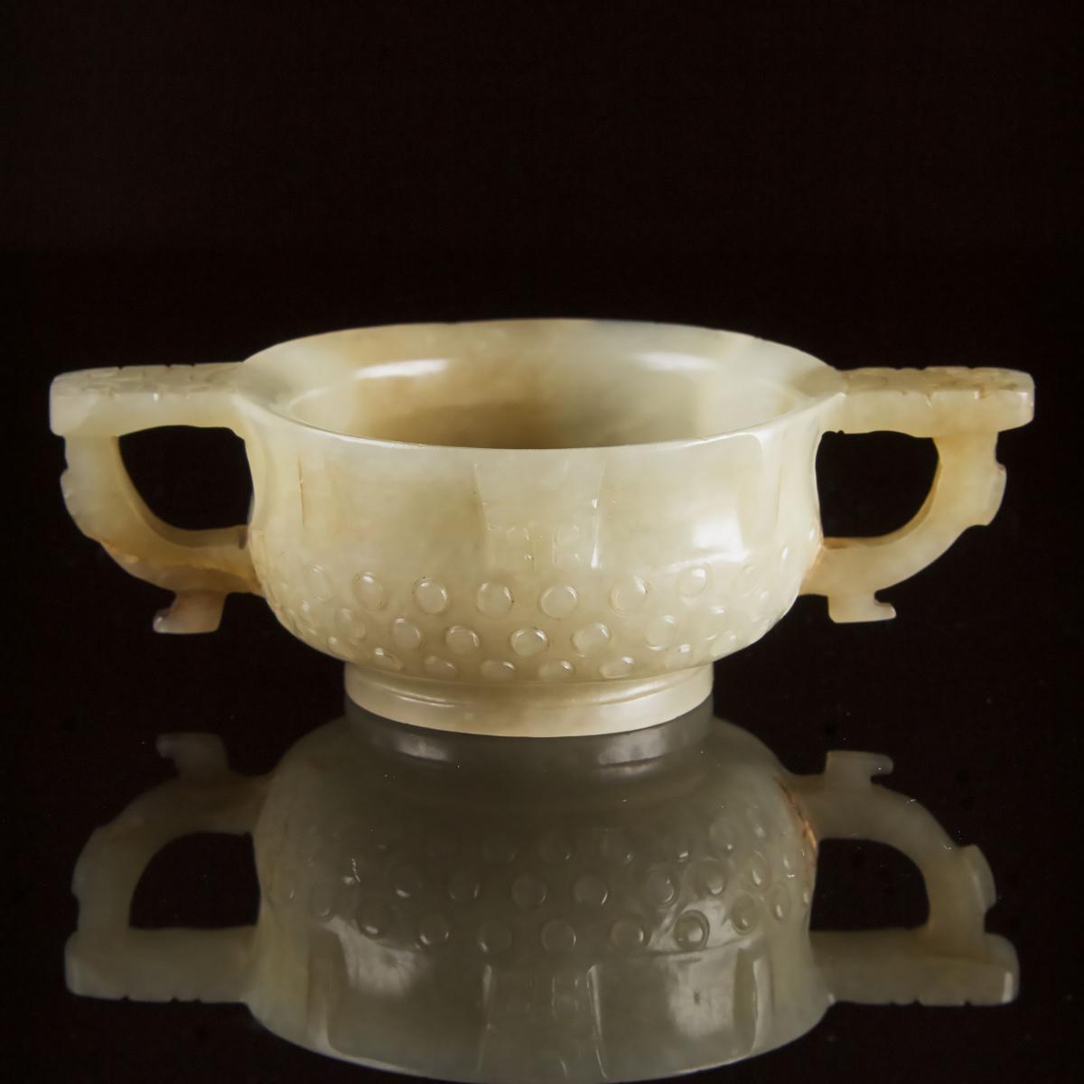 A Chinese Archaistic Celadon White Jade Libation Cup, Ming Dynasty, 17th Century, 明 青白玉雕乳钉兽面纹杯, 1.4 - Image 2 of 6