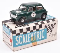 A Tri-ang Scalextric Austin Mini Cooper (C76). Example in green with driver, RN7. Boxed with