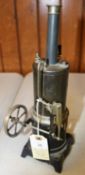 A Doll & Co. live steam tinplate stationary engine. Single cylinder vertical engine with whistle,