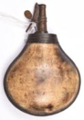 A mid 18th century brass mounted bulbous cow horn powder flask, 7" overall, the top with foliate