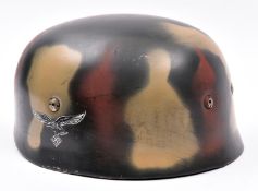 A re-enactment copy of a WWII German paratrooper’s steel helmet, with smooth camouflage painted