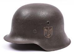 A Third Reich M42 single decal steel helmet, the skull with rough dark grey finish and eagle