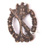 A Third Reich Infantry Assault badge in bronze, of solid flat back zinc with round pin and maker’s