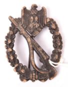 A Third Reich Infantry Assault badge in bronze, of solid flat back zinc with round pin and maker’s