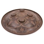 An Indian Benares brass shield, dhal, 11" diameter, with 4 domed bosses, decorated overall with