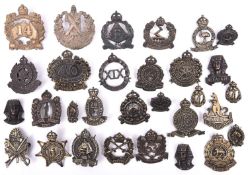 22 Australian cast brass cap badges, mostly pre WWII numbered infantry with bronzed or blackened