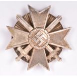A Third Reich War Merit Cross 1st class with swords, with rare screw back fitting. Near VGC £50-80