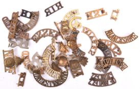 30 mostly brass Infantry shoulder titles, including large WM R-S (x2), pair small brass RS, Queens