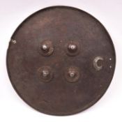 An Indian circular hide shield, dhal, 19th century or earlier,17½” diameter, with flour decorated