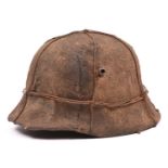 A German M16 style steel helmet, with glued on WWII style hessian covering, iron wire binding, and