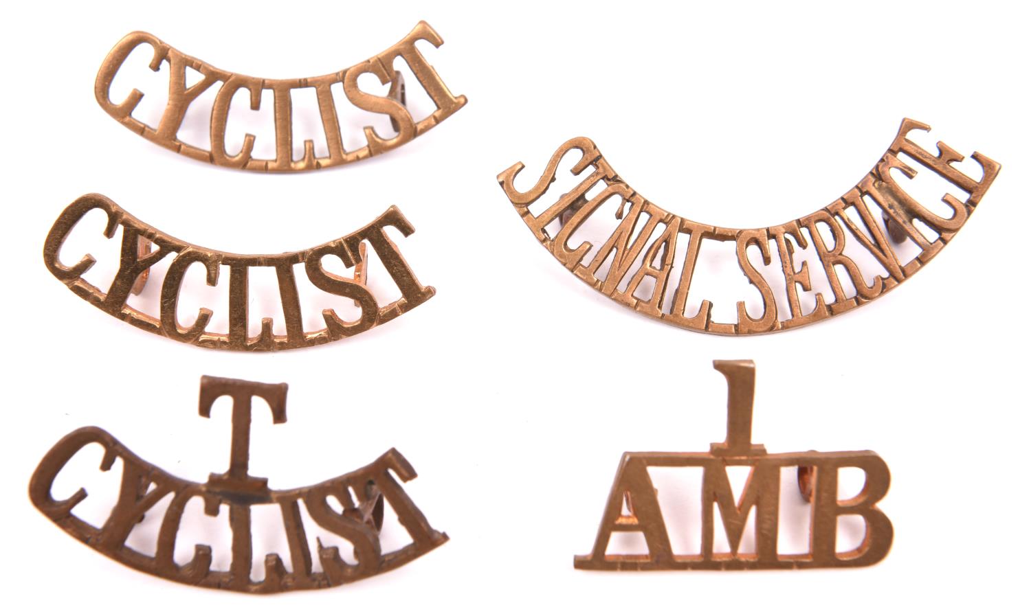 5 WWI period brass shoulder titles: 1/AMB (Armoured Motor Battery), T/CYCLIST, CYCLIST (x2), and