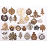 25 various Corps and other cap badges, including Artillery, GRVI Engineers, RAOC, GRVI RASC, Ryl