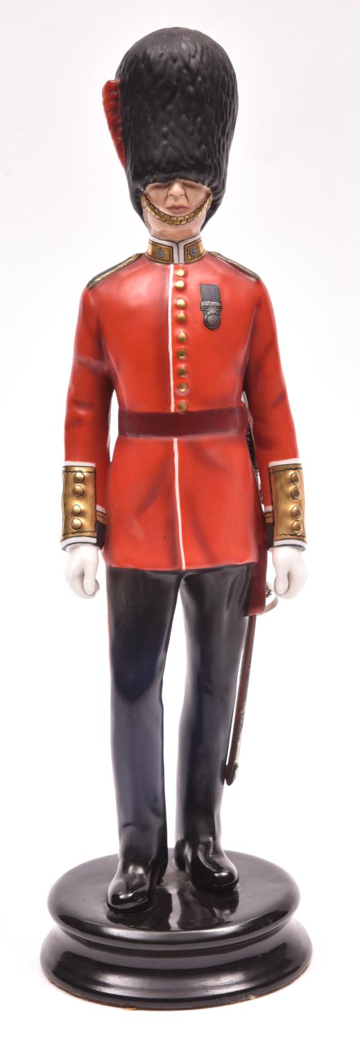 A fine Michael Sutty painted porcelain figure of an officer of the Coldstream Guards, wearing GS