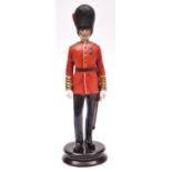 A fine Michael Sutty painted porcelain figure of an officer of the Coldstream Guards, wearing GS