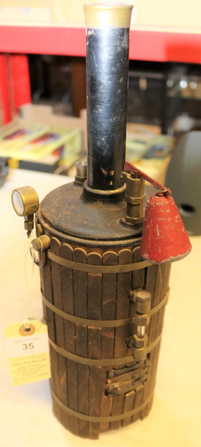 A live steam model of a Vertical Boiler. Coal fired model with separate grate sitting underneath