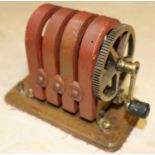 A hand-cranked magneto machine of brass and copper construction with 4 permanent magnets. 'No.8'