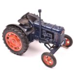 Chad Valley clockwork Fordson Major tractor. In dark blue with orange wheels and black rubber tyres.