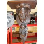 A mahogany bracket for a clock etc. The support decoratively carved with a head of a king surrounded