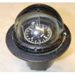 A Sestral Marine compass. Self leveling compass encased within a stand with sectional lid. Henry
