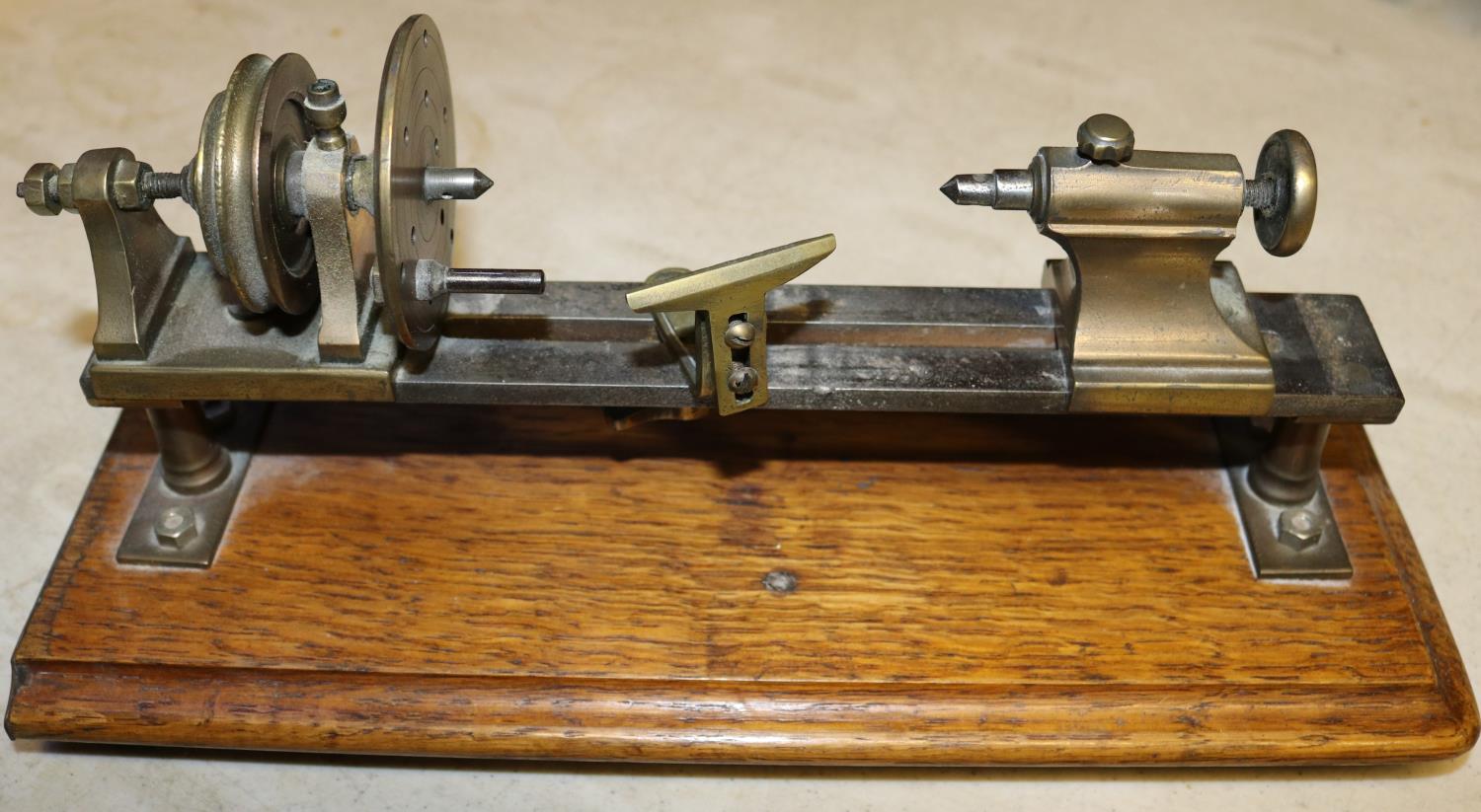 A small brass model of a basic wood turning lathe. Mounted on a hardwood plinth. Intended to be a - Image 3 of 3