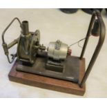 A Stuart Models dynamo. Rated at 4v. 1a. and 8000rpm. Connected to a brass steam driven fan and