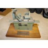 A small metal model of an industrial grinding machine. A well detailed model presented as a
