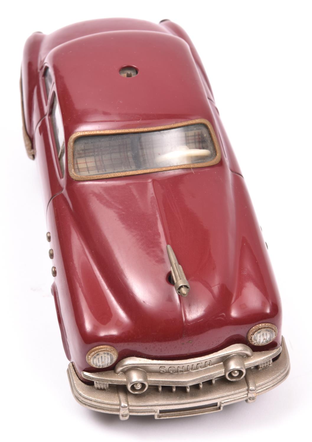 Schuco - Patient-Ingenico 5311 Tinplate 2 Door Saloon. A 1950's American style car in maroon with - Image 3 of 4