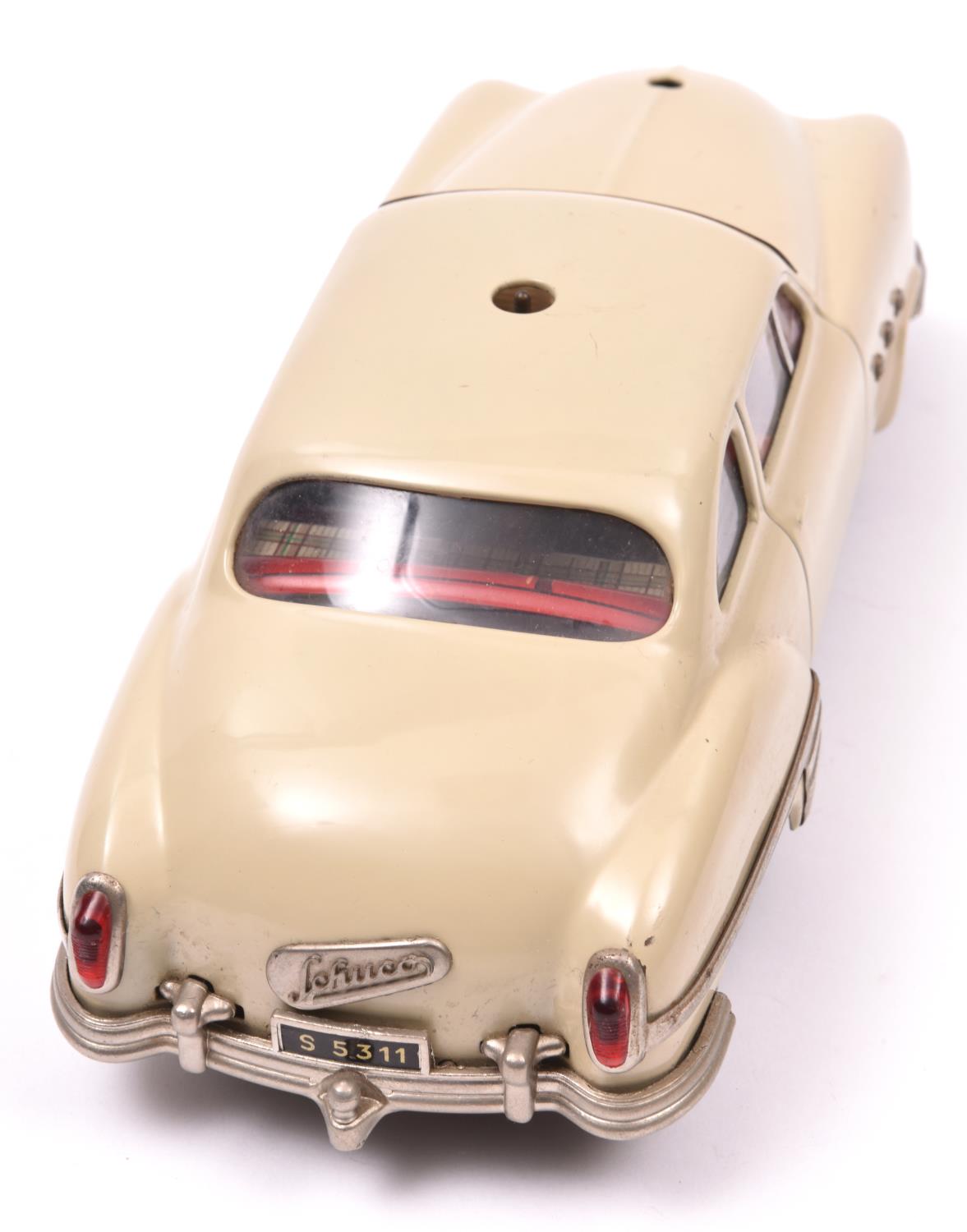 Schuco - Patient-Ingenico 5311 Tinplate 2 Door Saloon. A 1950's American style car in beige with a - Image 3 of 3