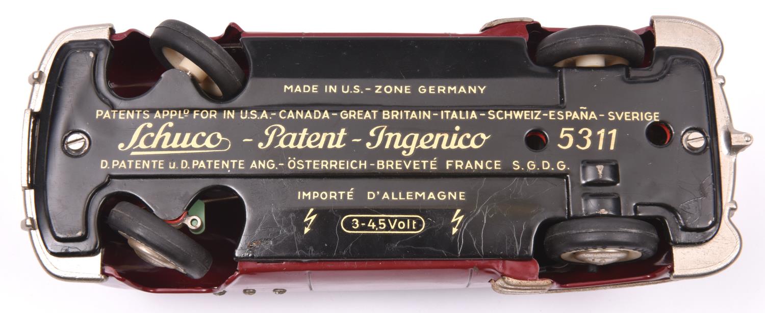 Schuco - Patient-Ingenico 5311 Tinplate 2 Door Saloon. A 1950's American style car in maroon with - Image 4 of 4