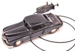 An Arnold Tinplate 2 Door Saloon FB2800. A hand-held coil wire driven example finished in black with