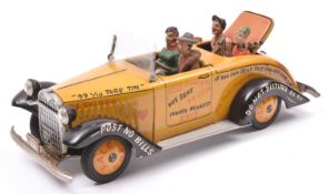 A scarce Arnold Tinplate friction powered 'Tin Lizzy'. In deep yellow with black mudguards, graffiti