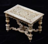 A very finely worked mid 19th Century oriental ivory doll's house model table with 17th Century