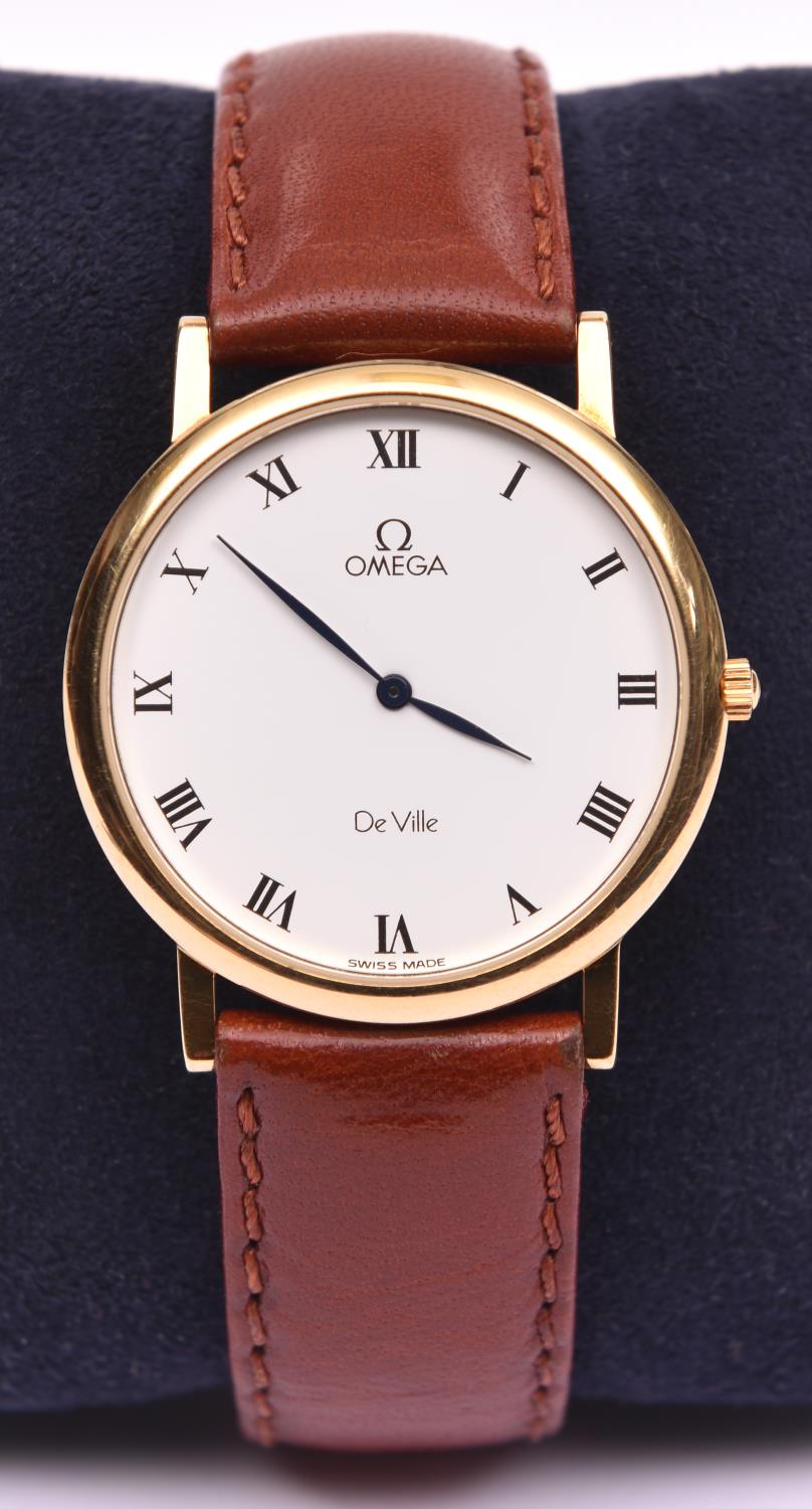 An Omega De Ville watch with quartz movement. Hallmarked 18 carat gold case, white face and black