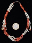 A mid-Victorian red and white 3-strand coral necklace made up of small pieces. GC, requires