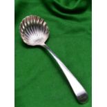 A Georgian silver sauce ladle with shell shaped bowl and decorated handle. Hallmarked London